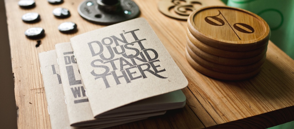 A printed notebook that says "don't just sand there"